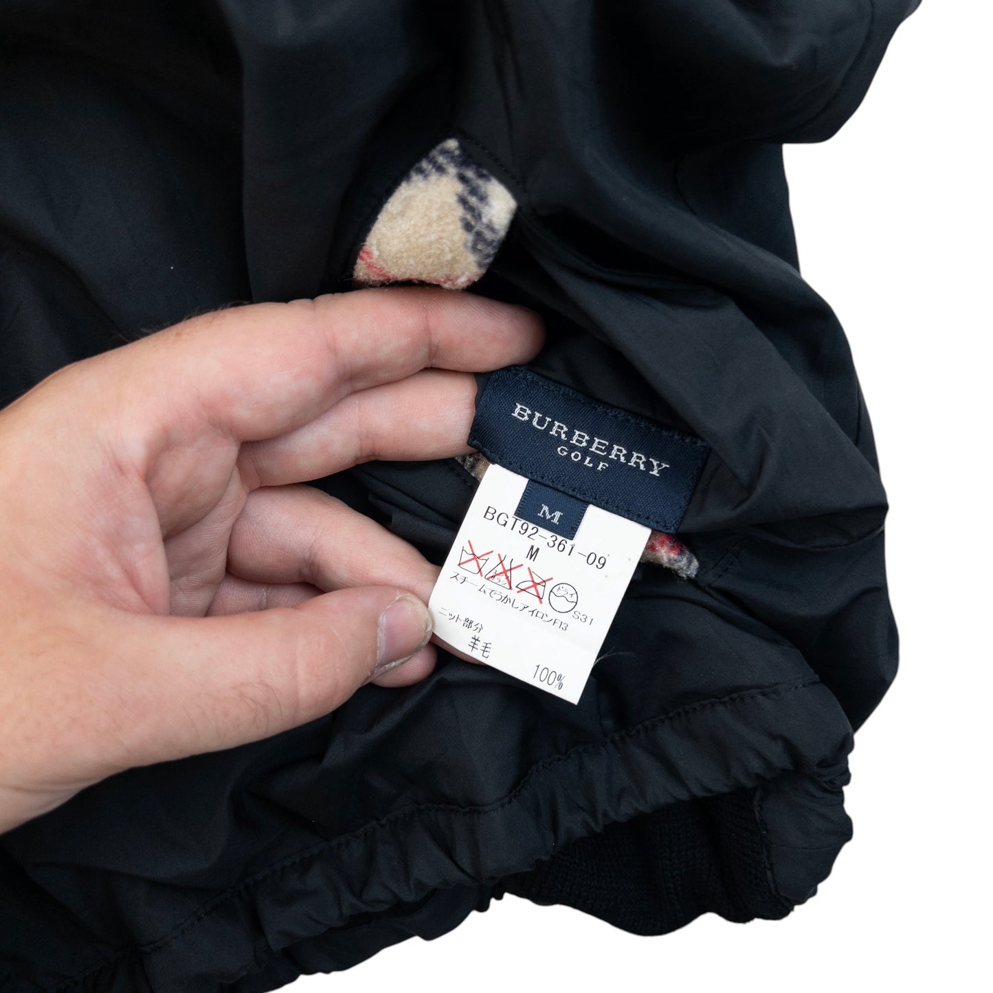 Burberry beige and black reversible jacket featuring classic Nova Check pattern and branded zipper pull.