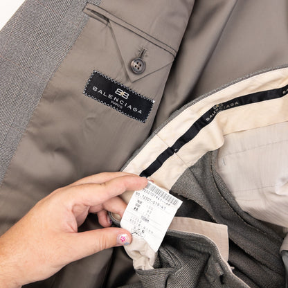 BALENCIAGA grey checkered suit set featuring a two-button jacket with flap pockets and pleated trousers