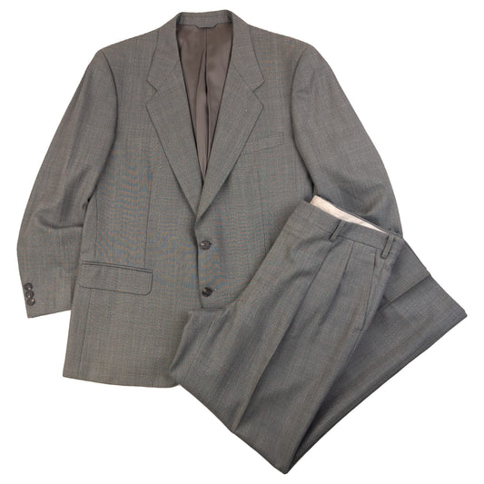 BALENCIAGA grey checkered suit set featuring a two-button jacket with flap pockets and pleated trousers