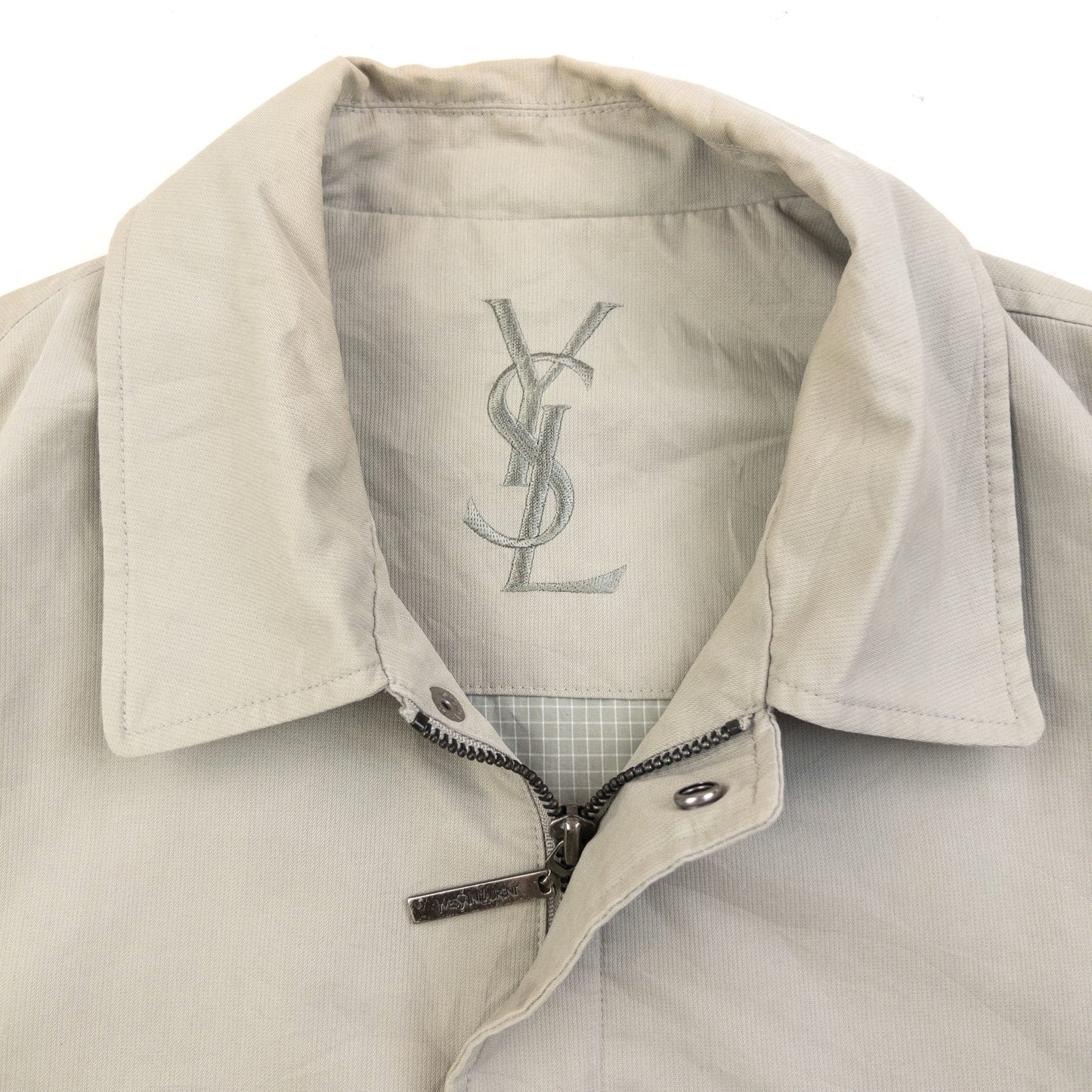 YVES SAINT LAURENT beige Harrington jacket with YSL embroidery on pocket and checkered lining.