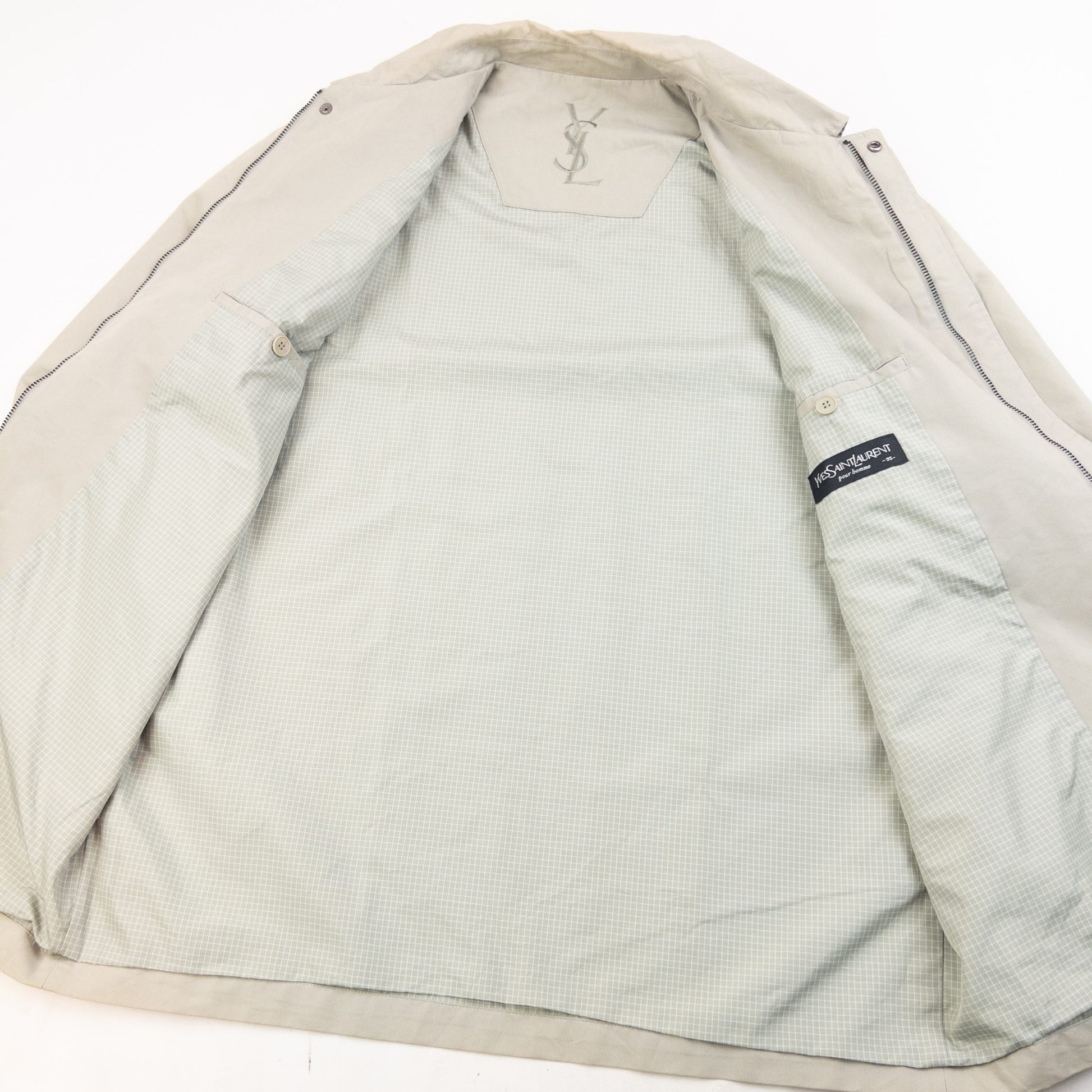 YVES SAINT LAURENT beige Harrington jacket with YSL embroidery on pocket and checkered lining.