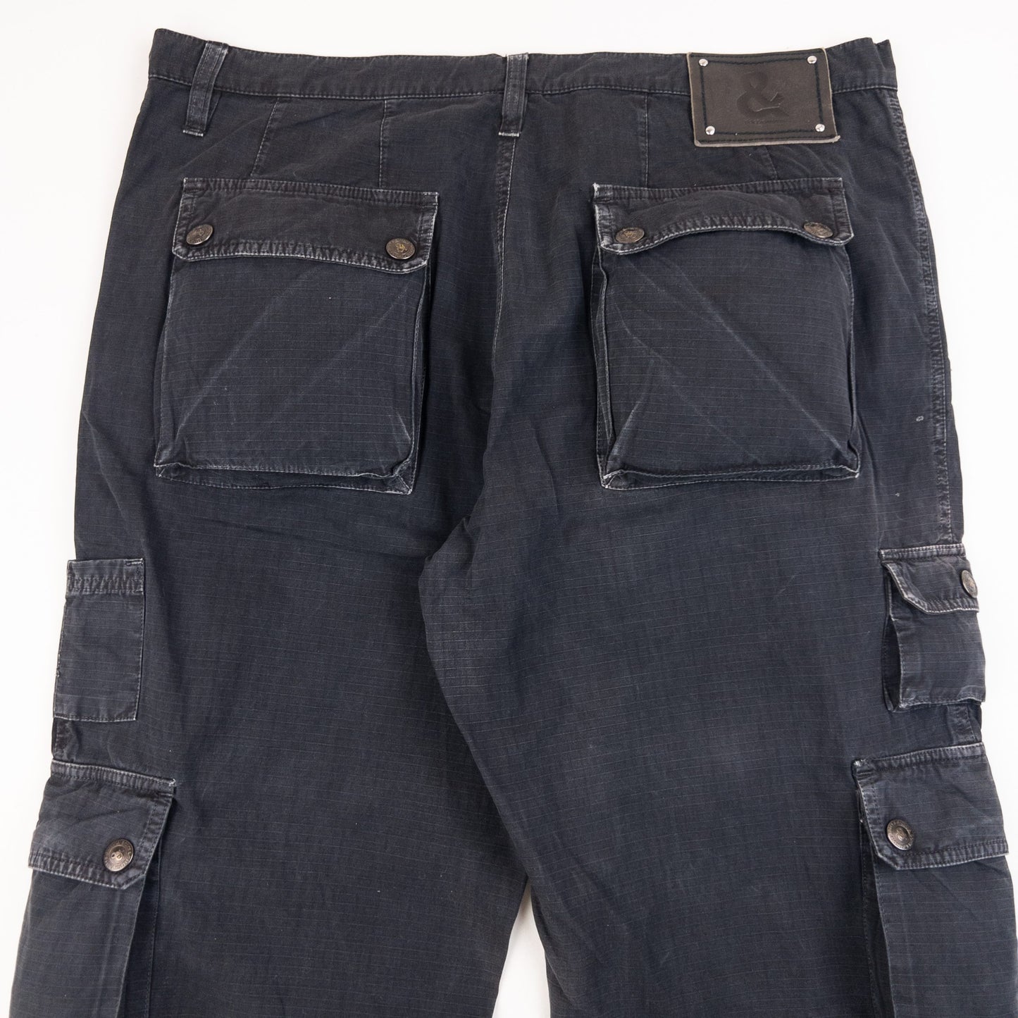 DOLCE & GABBANA black cargo trousers with multiple flap pockets and reinforced knee patches.