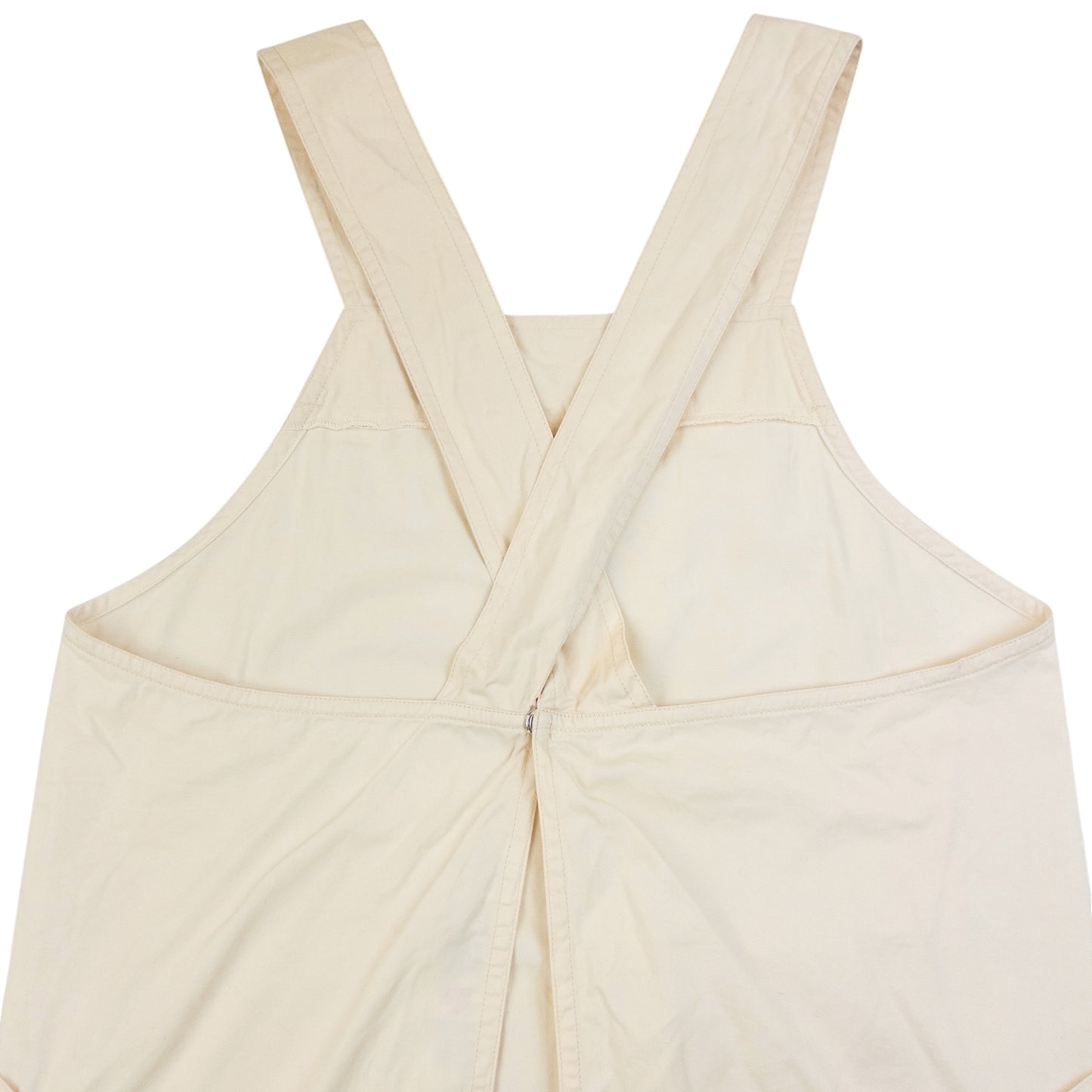 ISSEY MIYAKE beige apron with crossed back straps and stamped logo pocket detail