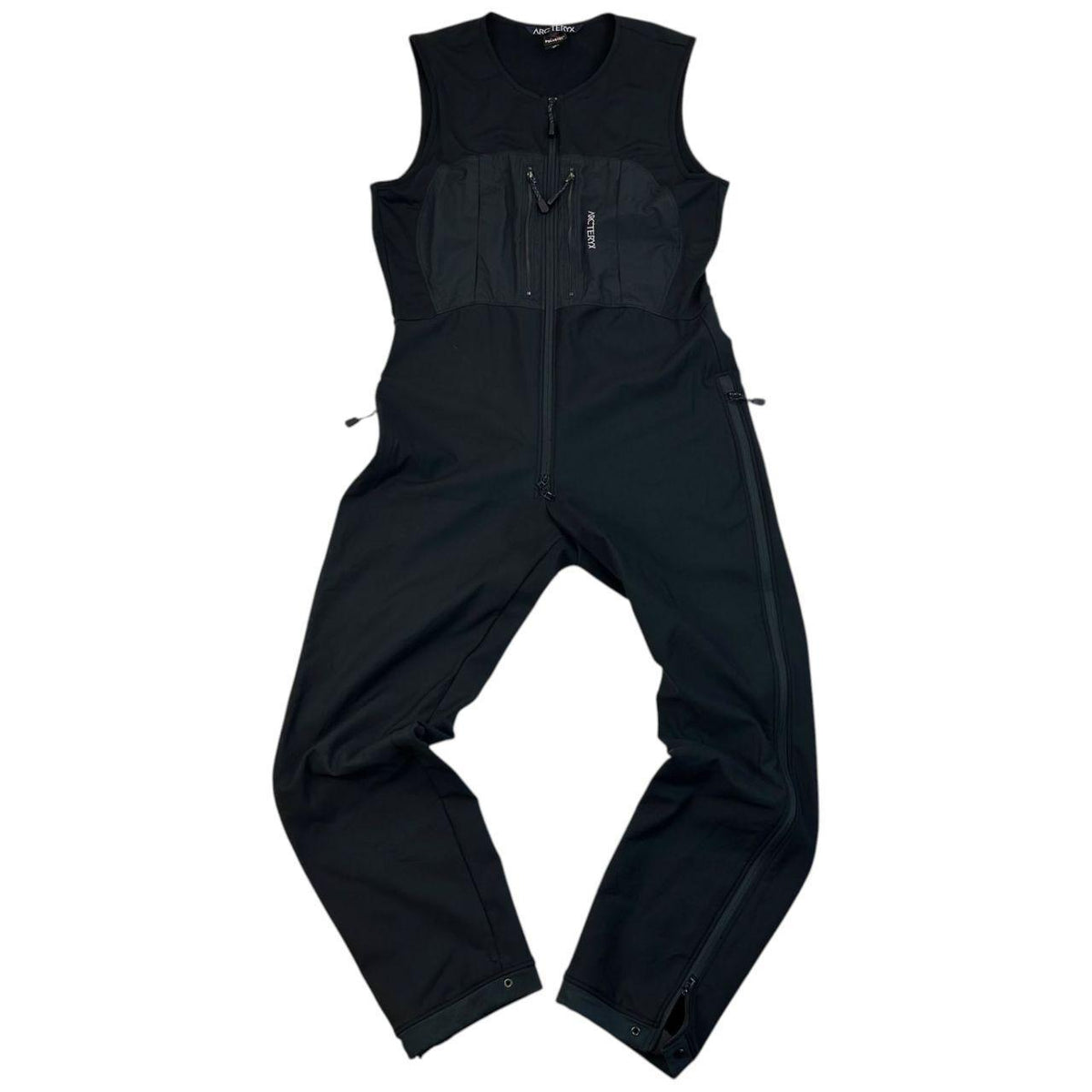 ARCTERYX black lightweight zip-up jumpsuit with distinctive logo on chest and zippered pockets.