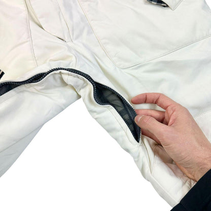 Burberry white ski overalls with logo detail on chest and adjustable straps.