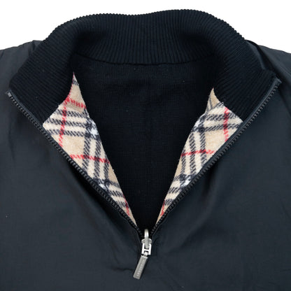 Burberry beige and black reversible jacket featuring classic Nova Check pattern and branded zipper pull.