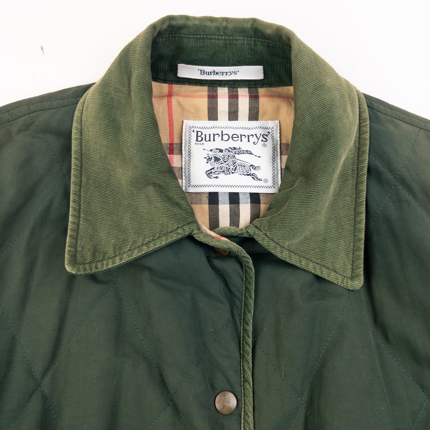 Burberry green quilted jacket with Nova Check lining, snap button closure, and corduroy collar.