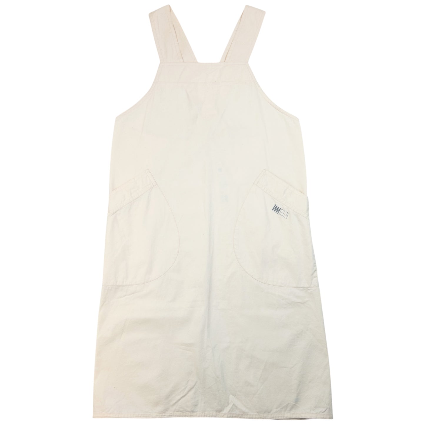 ISSEY MIYAKE beige apron with crossed back straps and stamped logo pocket detail