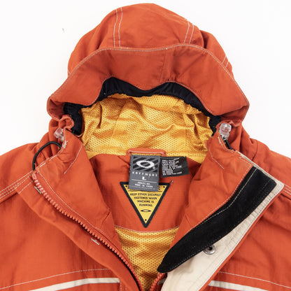 OAKLEY orange zip-up snowboarding jacket with reflective strip detail on chest and hood.