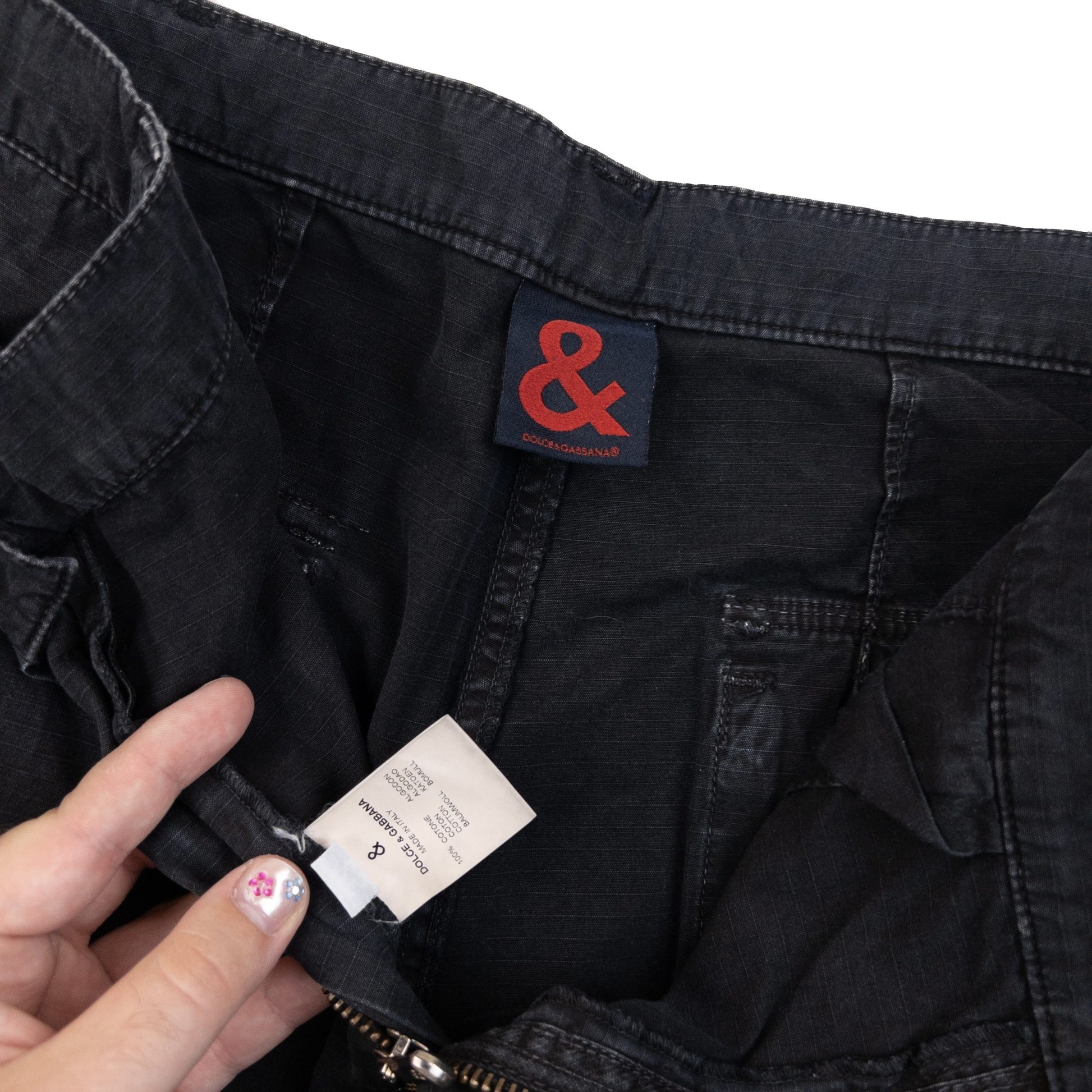 DOLCE & GABBANA black cargo trousers with multiple flap pockets and reinforced knee patches.