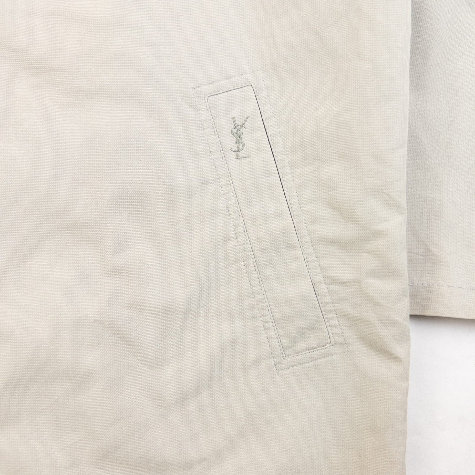 YVES SAINT LAURENT beige Harrington jacket with YSL embroidery on pocket and checkered lining.